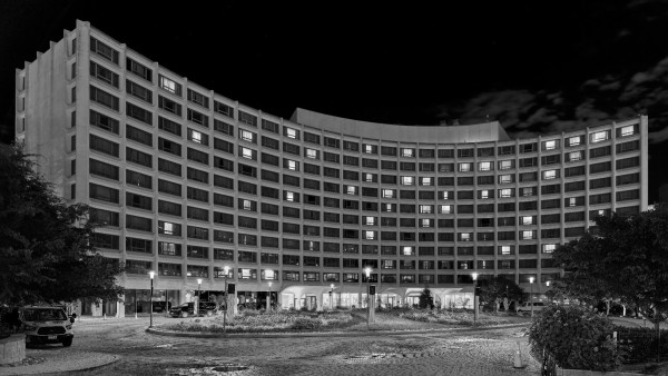 A brutalist hotel building at night